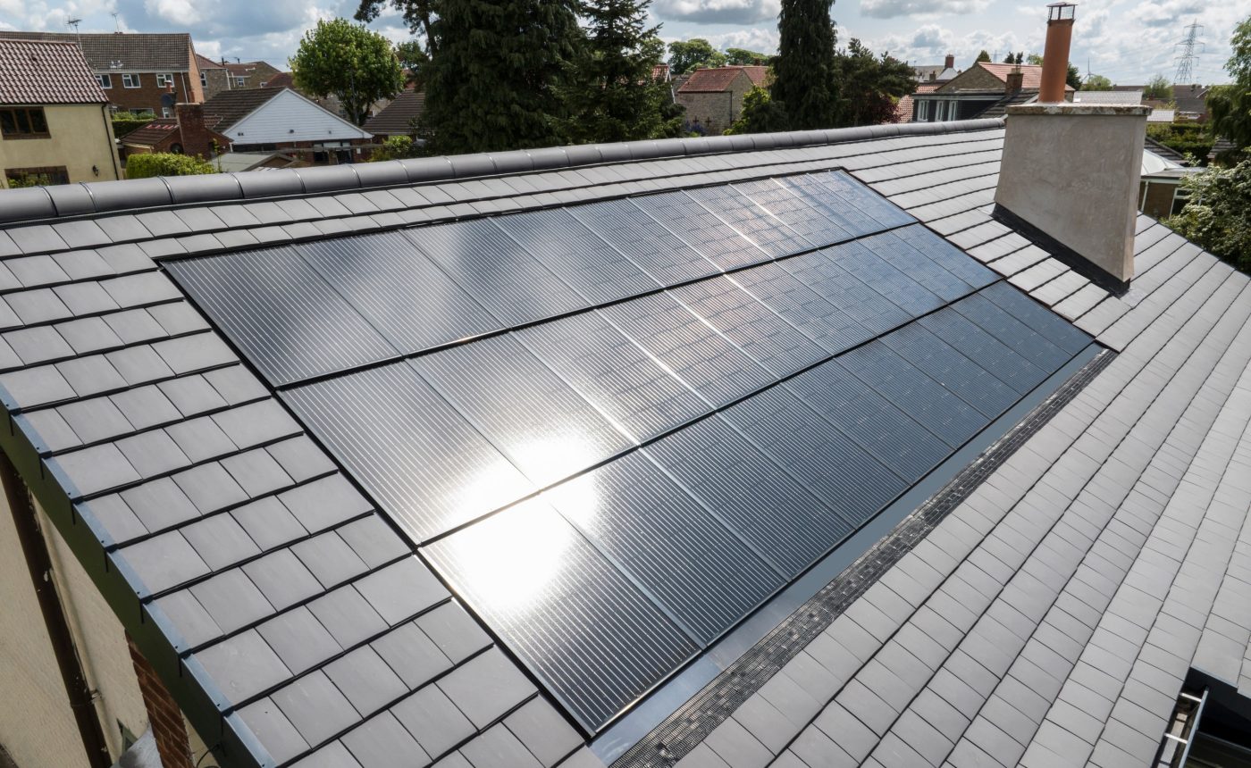 In-roof solar panel system installed flush within the roof plane, no raised racking visible