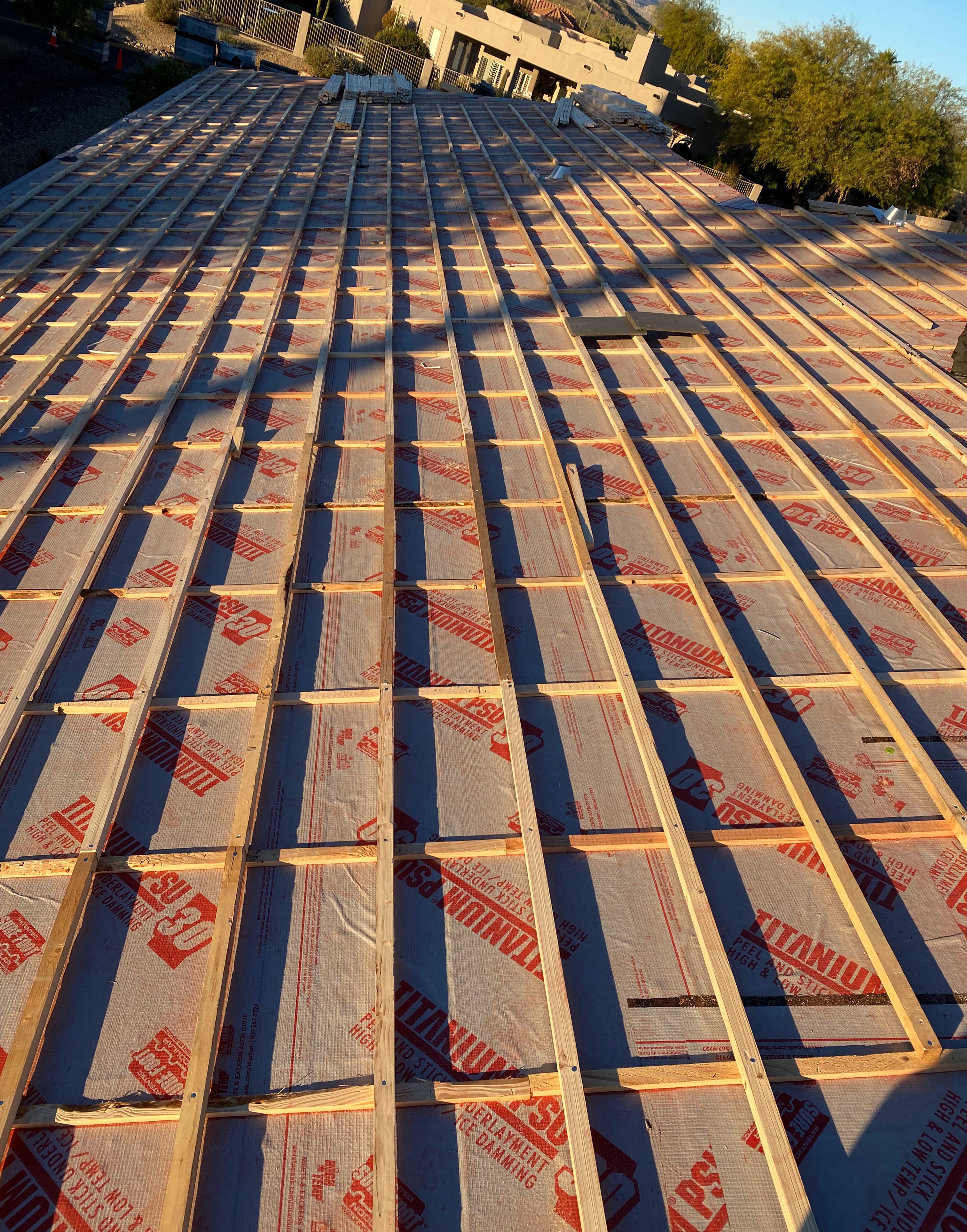 A full double batten grid, counter-battens and battens, laid over peel and stick underlayment before tile goes down