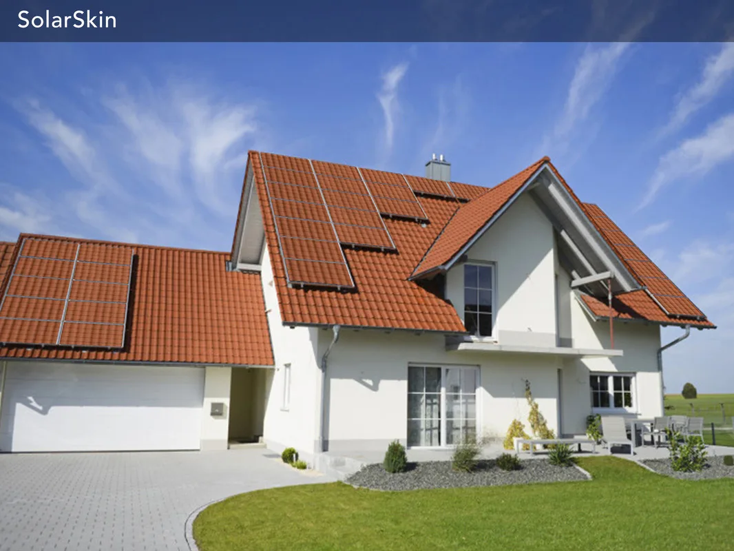 Solar skin applied over panel surface, printed to match surrounding roof material